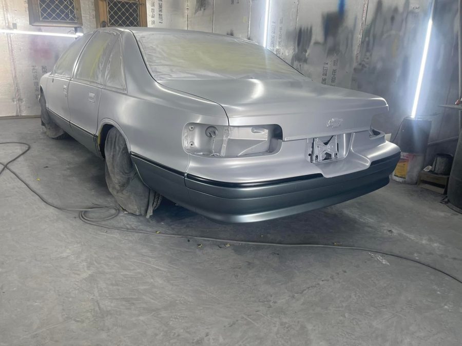 Sedan mid-repaint in the paint booth